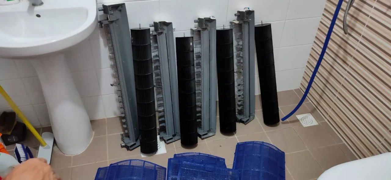 Cleaned aircon blowers and components prepared for reassembly