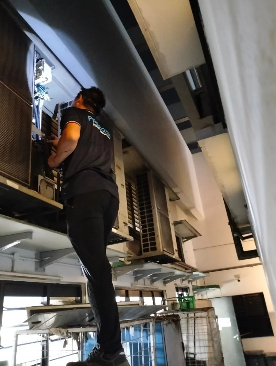 Freezso technician servicing outdoor aircon units